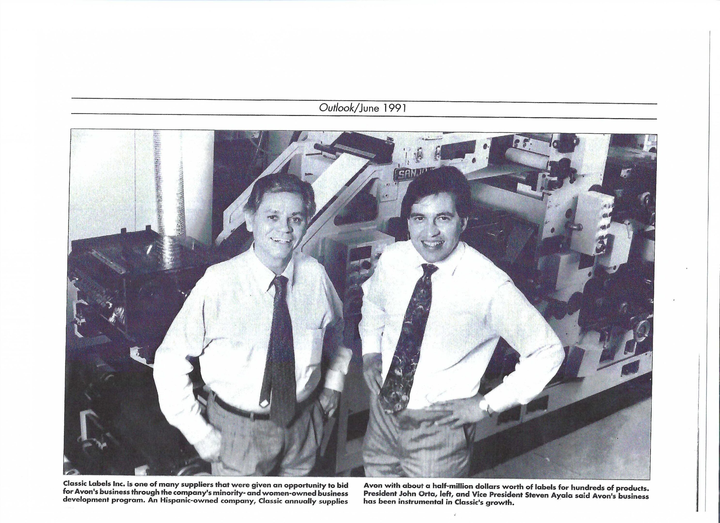 Two businessmen standing by industrial label printing machine