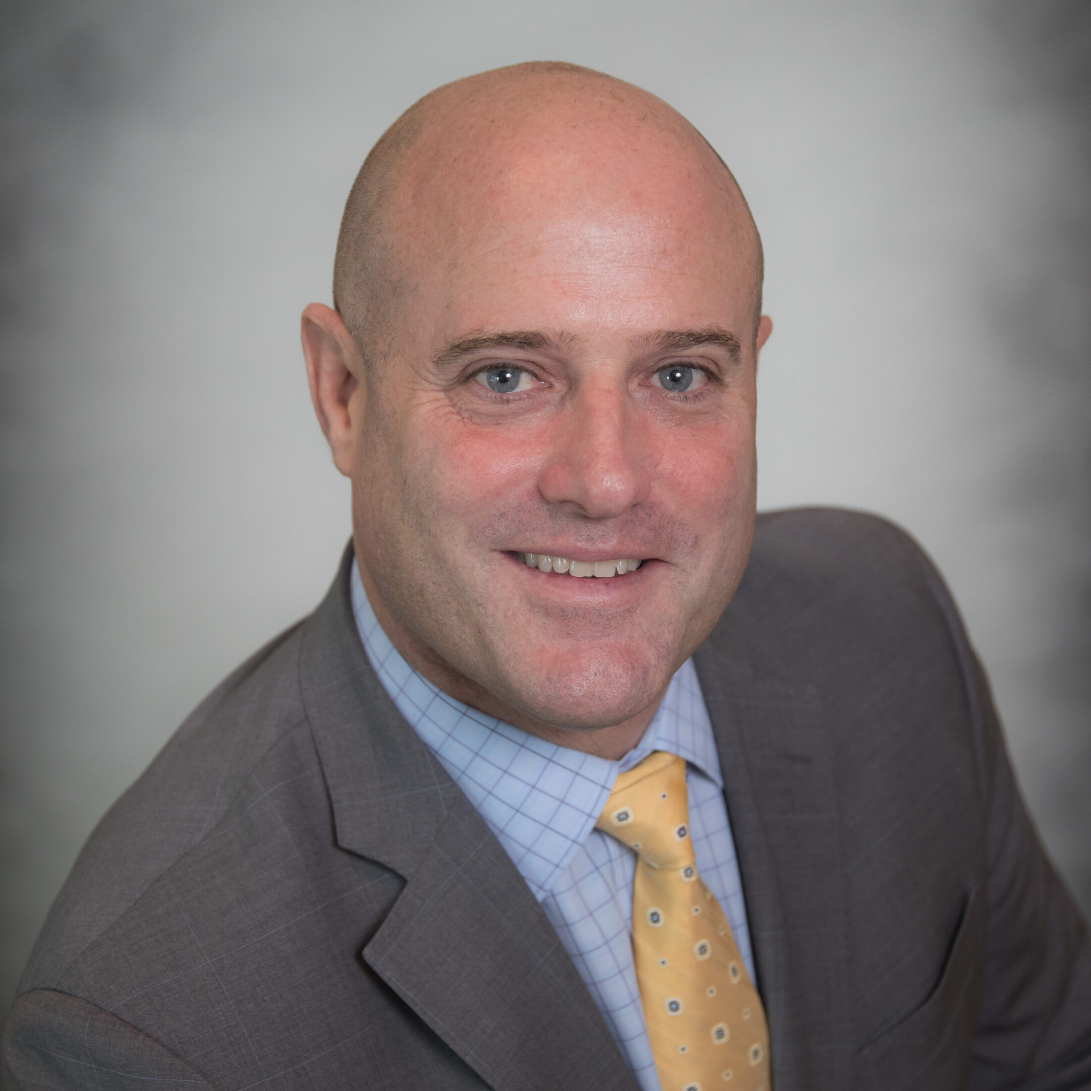 Smiling bald man in suit and tie