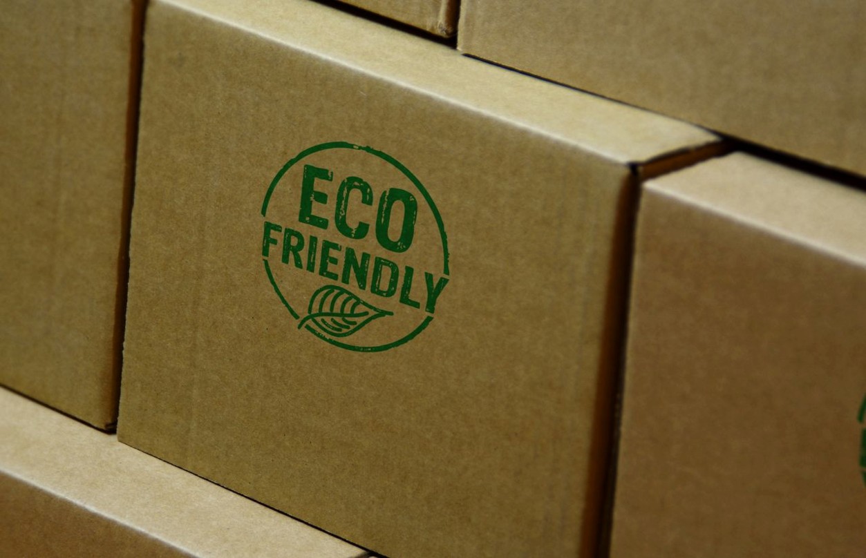 Stacked cardboard boxes with green ECO FRIENDLY logo
